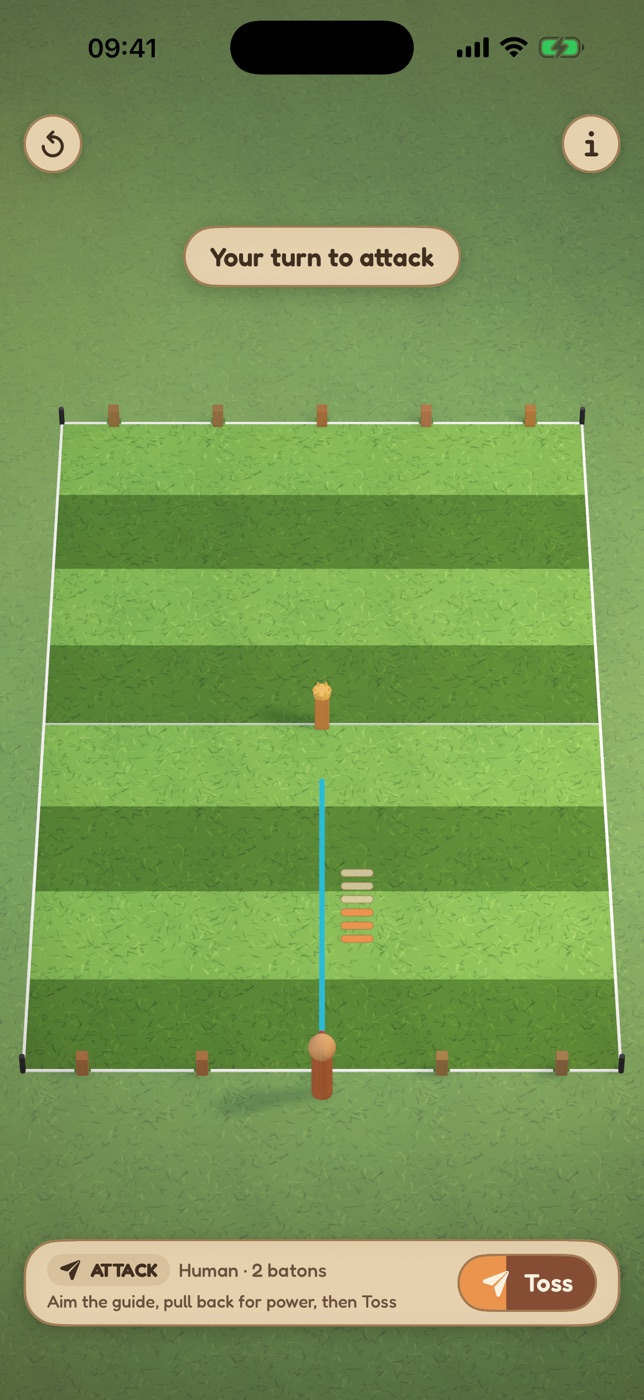The Kubb Toss pitch in play: a row of wooden kubbs along the back line, the crowned king in the middle, and the throw guide aimed from the near baseline.